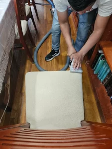 Cleaning a dining chair seat on Long Island